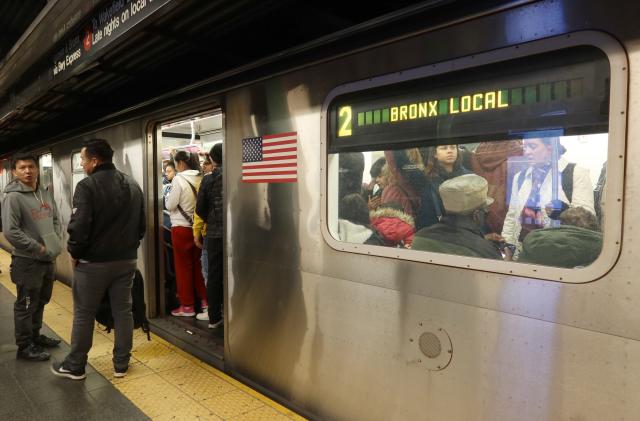 NEW YORK, NY - NOVEMBER 6: Two people wait on a platform to board a 2 train at the Times Sqaure subway station on November 6, 2023, in New York City.  (Photo by Gary Hershorn/Getty Images)