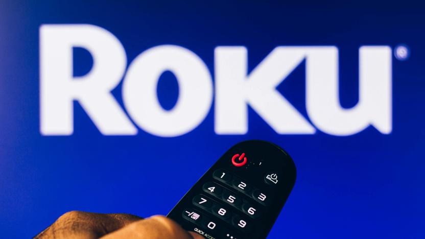 BRAZIL - 2022/02/21: In this photo illustration, a hand holding a TV remote control points to a screen that displays the Roku logo. (Photo Illustration by Rafael Henrique/SOPA Images/LightRocket via Getty Images)