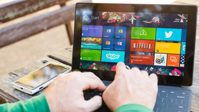 Ankara, Turkey - September 8, 2013:  Man using his surface tablet at the park. Microsoft Surface is a series of tablets designed and marketed by Microsoft