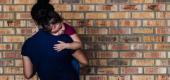 A migrant girl with her mother. (Getty Images)