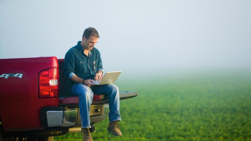 Farmer Using Laptop from Tailgate of Truck