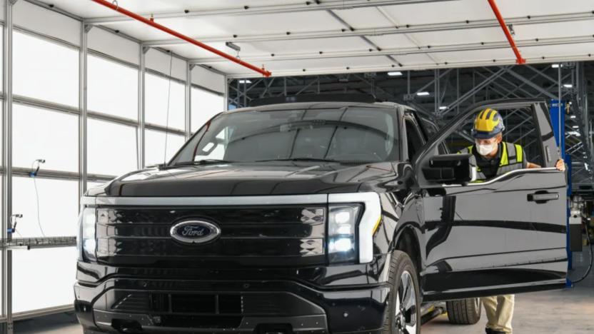 A factory worker looking inside of a Ford EV truck.