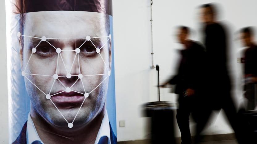 People walk past a poster simulating facial recognition software at the Security China 2018 exhibition on public safety and security in Beijing, China October 24, 2018.   REUTERS/Thomas Peter