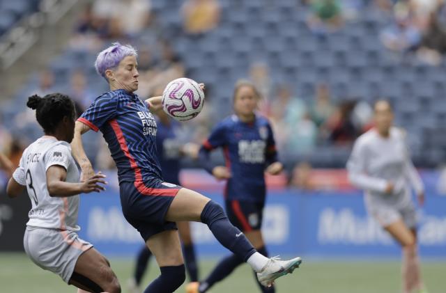 May 27, 2023; Seattle, Washington, USA; OL Reign forward Megan Rapinoe (15) plays the ball pressured by Angel City FC forward Jasmyne Spencer (3) in the first half at Lumen Field. Mandatory Credit: John Froschauer-USA TODAY Sports