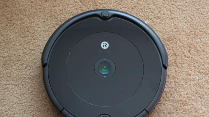 This is a robot vacuum on a carpet.