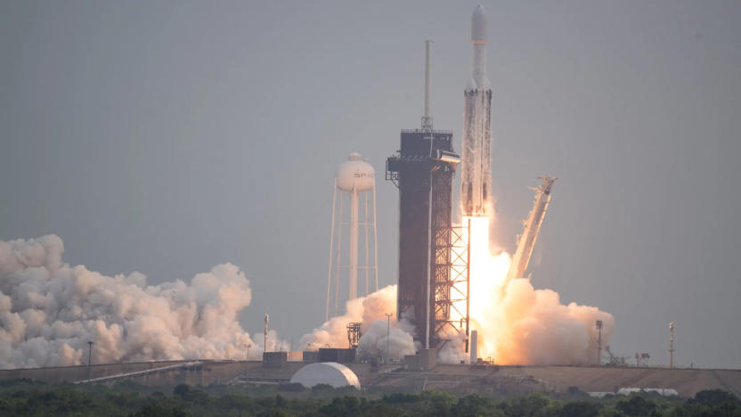 Photo of a SpaceX rocket, with the Psyche spacecraft attached to it, blasting off.