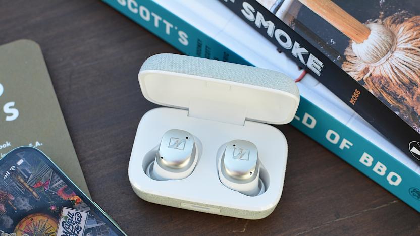 White/silver Sennheiser Momentum True Wireless 4 earbuds sitting in their case with the lid open.