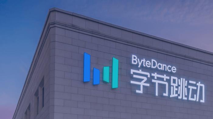 Image (at either dusk or dawn) of part of the building for ByteDance headquarters with the company's name and logo near the roof.