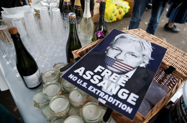 A view shows a placard depicting WikiLeaks founder Julian Assange, near bottles of sparkling wine belonging to his supporters, on the day of his and Stella Moris' wedding at HMP Belmarsh prison, in London, Britain, March 23, 2022. REUTERS/Peter Nicholls