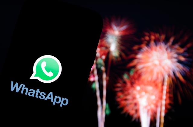 POLAND - 2020/12/30: In this photo illustration a Whatsapp logo seen displayed on a smartphone with fireworks in the background. (Photo Illustration by Filip Radwanski/SOPA Images/LightRocket via Getty Images)