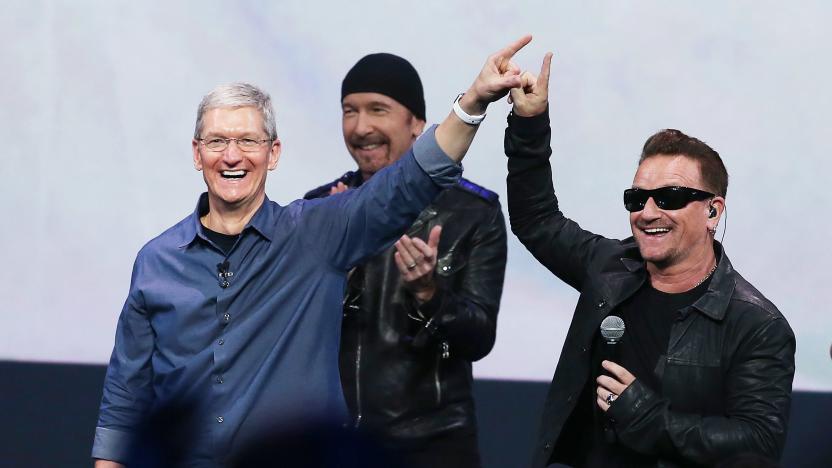 CUPERTINO, CA - SEPTEMBER 09:  Apple CEO Tim Cook (L) greets the crowd with U2 singer Bono (R) as The Edge looks on during an Apple special event at the Flint Center for the Performing Arts on September 9, 2014 in Cupertino, California. Apple unveiled the Apple Watch wearable tech and two new iPhones, the iPhone 6 and iPhone 6 Plus.  (Photo by Justin Sullivan/Getty Images)