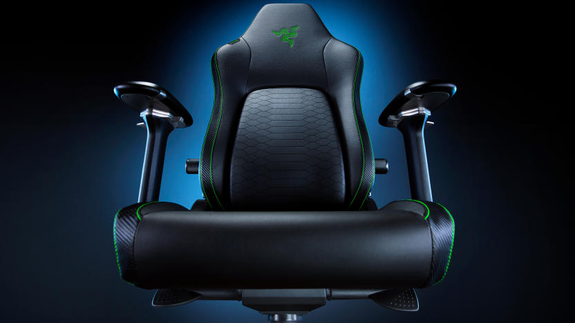 Product marketing photo of the Razer Iskur V2 Gaming Chair. Taken from a lower angle (just above the seat area), the dramatic shot has a blue glow fading to black behind the chair.