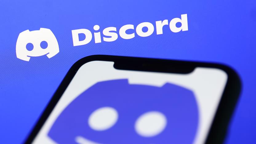 Discord logo displayed on a phone screen and Discord website displayed on a screen in the background are seen in this illustration photo taken in Krakow, Poland on November 5, 2022. (Photo by Jakub Porzycki/NurPhoto via Getty Images)