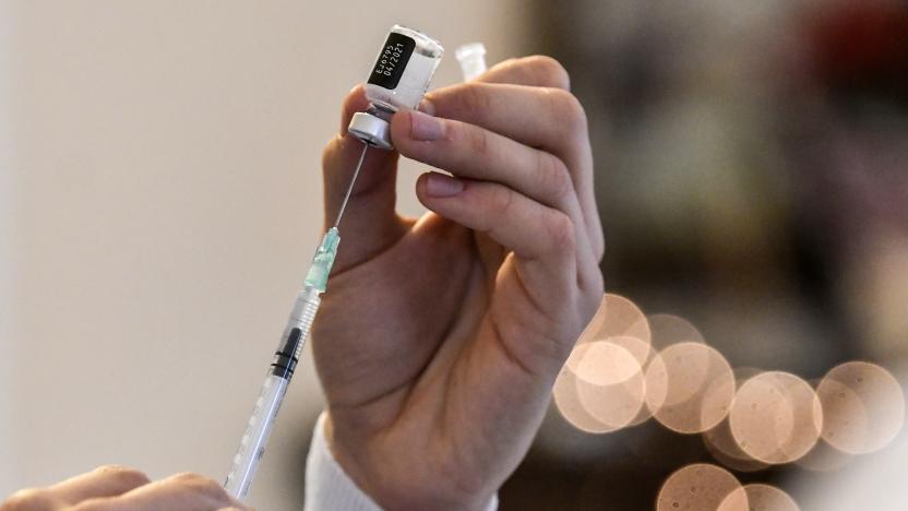 A nurse prepares a vaccine prior to the vaccination of elderly people at a nursing house in Athens, Monday, Jan. 4, 2021. Vaccinations were expanded from 9 to 50 hospitals nationwide on Monday. (Louisa Gouliamaki/Pool via AP)