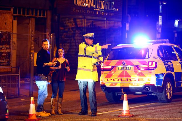Police stand by a cordoned off street close to the Manchester Arena on May 22, 2017 in Manchester, England.