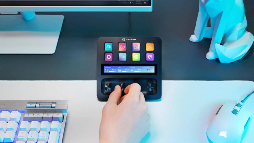 The Elgato Stream Deck + is set up on a desk near a keyboard monitor and mouse. A person twists the programmable dials. 