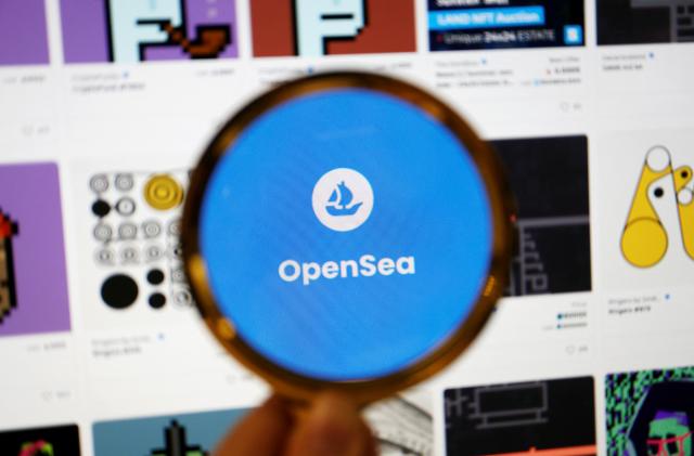 The logo of non-fungible token (NFT) marketplace OpenSea is seen through a magnifying glass amid NFT items displayed on its website, in this illustration picture taken February 28, 2022. REUTERS/Florence Lo/Illustration