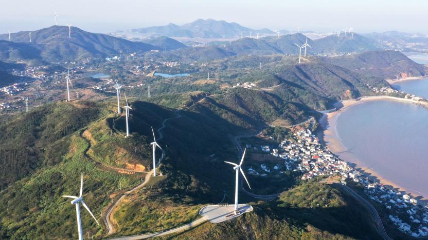 ZHOUSHAN, CHINA - NOVEMBER 24, 2021 - An aerial photo taken on November 24, 2021 shows wind turbines rotating under sea breeze at a wind farm in Zhoushan City, Zhejiang Province, China. (Photo credit should read Zou Xunyong / Costfoto/Barcroft Media via Getty Images)