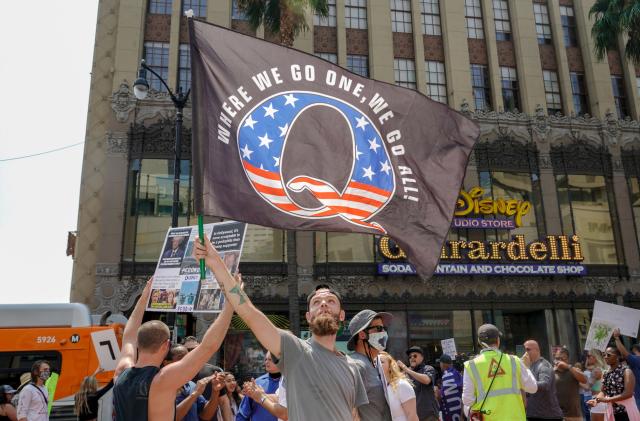 Conspiracy theorist QAnon demonstrators protest child trafficking on Hollywood Boulevard in Los Angeles, California, August 22, 2020. - A 2019 bulletin from the FBI warned that conspiracy theory-driven extremists are a domestic terrorism threat. (Photo by Kyle Grillot / AFP) (Photo by KYLE GRILLOT/AFP via Getty Images)