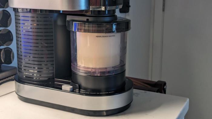 Photo of the Ninja Creami ice cream maker, with a closeup on its container filled with ice cream.