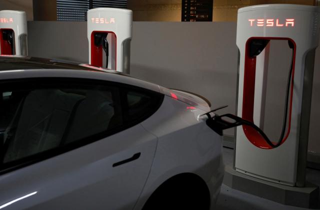 A Tesla car charges at a Supercharger station in Singapore October 22, 2021. Picture taken October 22, 2021. REUTERS/Edgar Su