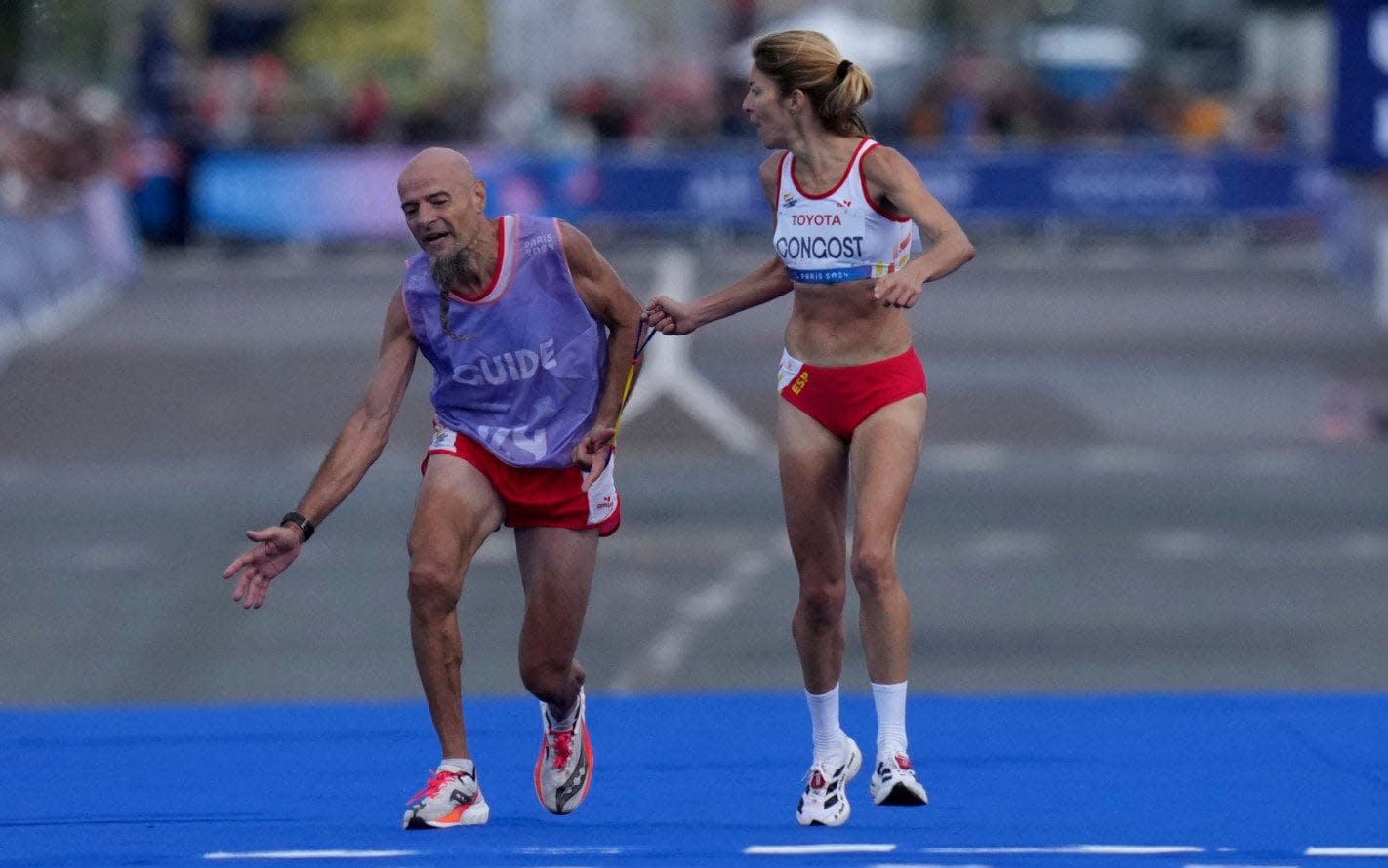 Paralympics marathon runner stripped of medal after helping guide with cramp metres from finish