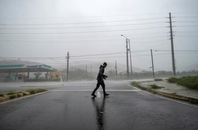 A man stands in the strong winds of Hurricane Fiona in Ponce, Puerto Rico September 18, 2022.  REUTERS/Ricardo Arduengo