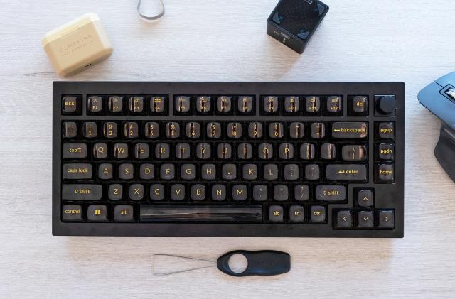 An overhead view of the new Q1 Pro mechanical keyboard from Keychron on a desk along with some accessories.