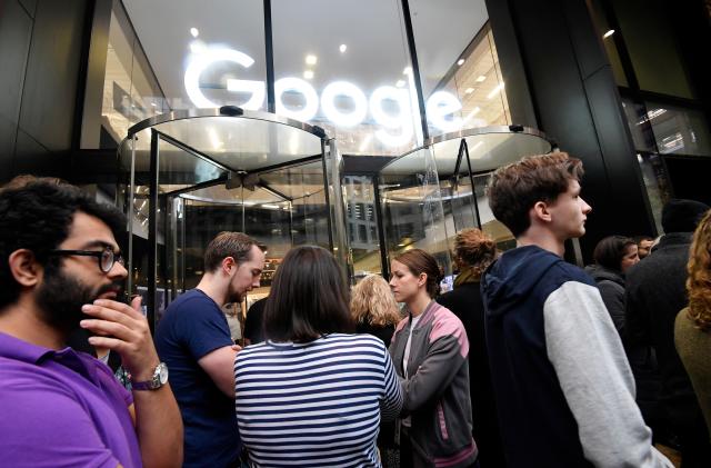 Workers stand outside the Google offices after walking out as part of a global protest over workplace issues, in London, Britain, November 1, 2018. REUTERS/Toby Melville