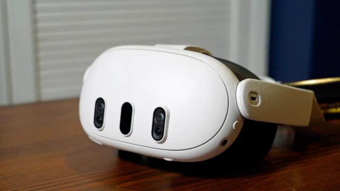 A white headset on top of a wooden table.