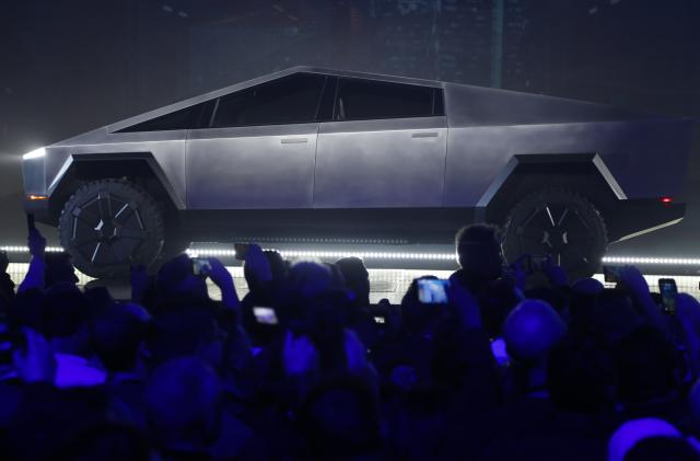 File - The Tesla Cybertruck is unveiled at Tesla's design studio on Nov. 21, 2019, in Hawthorne, Calif. Tesla CEO Elon Musk is expected to give an update on manufacturing problems with long-awaited Cybertruck at an event Thursday marking the first deliveries of the futuristic, angular pickup truck. (AP Photo/Ringo H.W. Chiu, File)