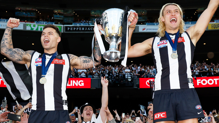 Getty Images - MELBOURNE, AUSTRALIA - SEPTEMBER 30: Jamie Elliott and Darcy Moore of the Magpies celebrate with the premiership cup during the 2023 AFL Grand Final match between the Collingwood Magpies and the Brisbane Lions at the Melbourne Cricket Ground on September 30, 2023 in Melbourne, Australia. (Photo by Dylan Burns/AFL Photos via Getty Images)