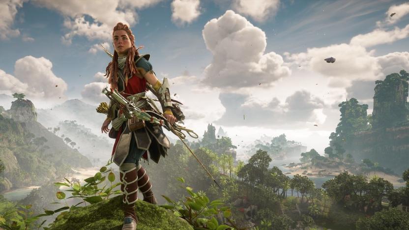 Aloy stands on a hill with lush vegetation behind her in Horizon Forbidden West.