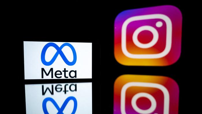 This picture taken on January 12, 2023 in Toulouse, southwestern France shows a smartphone and a computer screen displaying the logos of Instagram app and its parent company Meta. (Photo by Lionel BONAVENTURE / AFP) (Photo by LIONEL BONAVENTURE/AFP via Getty Images)