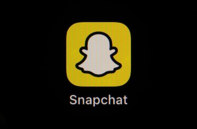 The icon for instant messaging app Snapchat is seen on a smartphone, Feb. 28, 2023, in Marple Township, Pa. The owner of Snapchat is cutting approximately 10% of its worldwide workforce, or about 528 employees, just the latest tech company to announce layoffs. Snap Inc. said in a regulatory filing that it currently estimates $55 million to $75 million in charges, mostly for severance and related costs. (AP Photo/Matt Slocum)