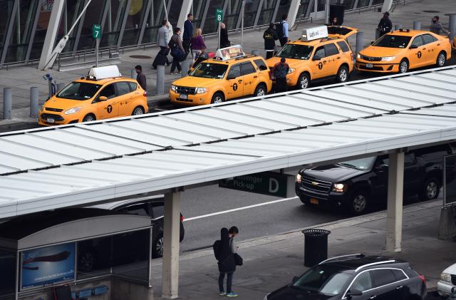 Arriving passengers line up to get taxi outside of Terminal 4 at the JFK airport in New York on October 11, 2014. The airport started health screenings for travelers arriving from Ebola-hit West African nations on October 11, as the death toll from the deadly virus topped 4,000. Passengers arriving from Liberia, Sierra Leone and Guinea will have their temperatures taken, be assessed for signs of illness and answer questions about their health and exposure history, the US Centers for Disease Control and Prevention (CDC) said.   AFP PHOTO/Jewel Samad        (Photo credit should read JEWEL SAMAD/AFP via Getty Images)