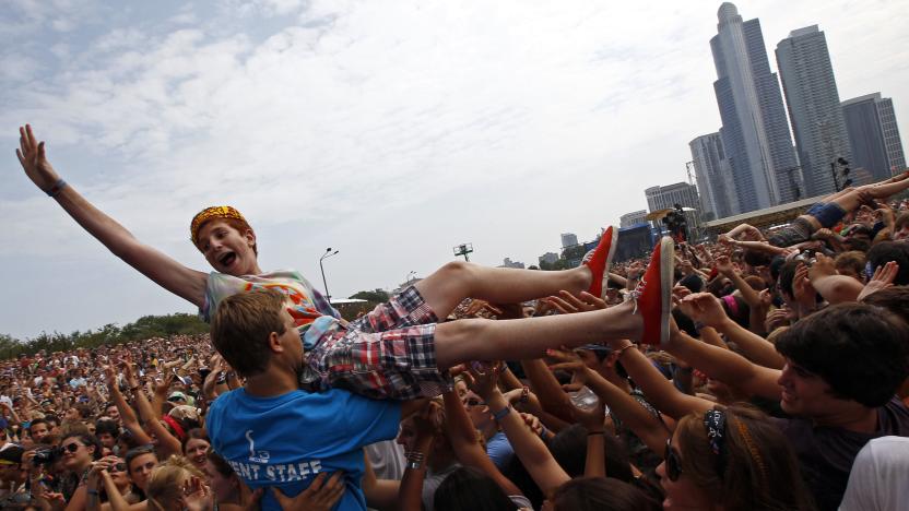 A music fan crowd surfs during a performance by "Foster the People" at the Lollapalooza music festival in Grant Park in Chicago, August 5, 2011. The giant rock festival celebrating its 20th anniversary will run three days of music with 140 artists set to perform.  REUTERS/Jim Young      (UNITED STATES - Tags: ENTERTAINMENT)