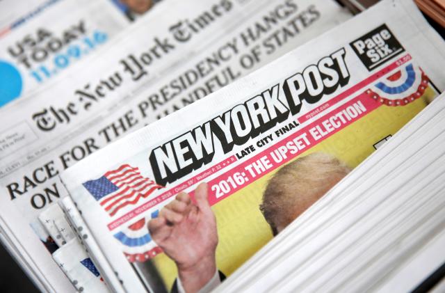The cover of the New York Post newspaper is seen with other papers at a newsstand in New York U.S., November 9, 2016. REUTERS/Shannon Stapleton