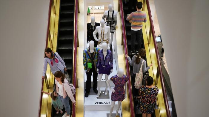 FILE - Shoppers move past displays of designer clothes at the Neiman Marcus department store in NorthPark shopping center in Dallas, March 30, 2023.The parent company of Saks Fifth Avenue has signed a deal to buy upscale rival Neiman Marcus Group, which owns Neiman Marcus and Bergdorf Goodman stores, in a deal announced on Thursday, July 4, 2024. (AP Photo/LM Otero, File)