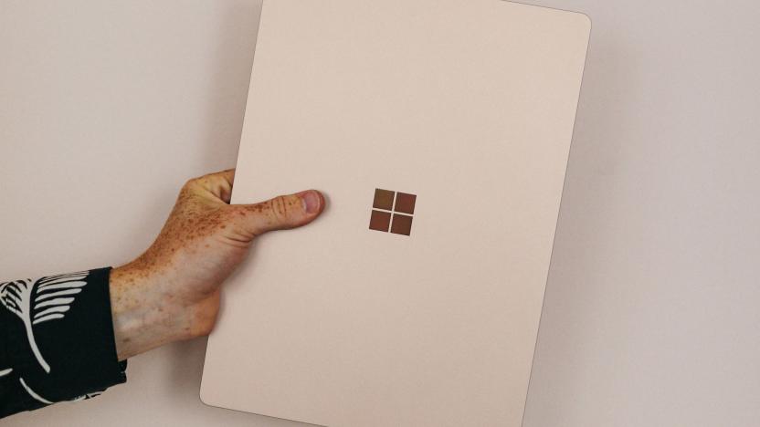 A hand holding a Microsoft device. 