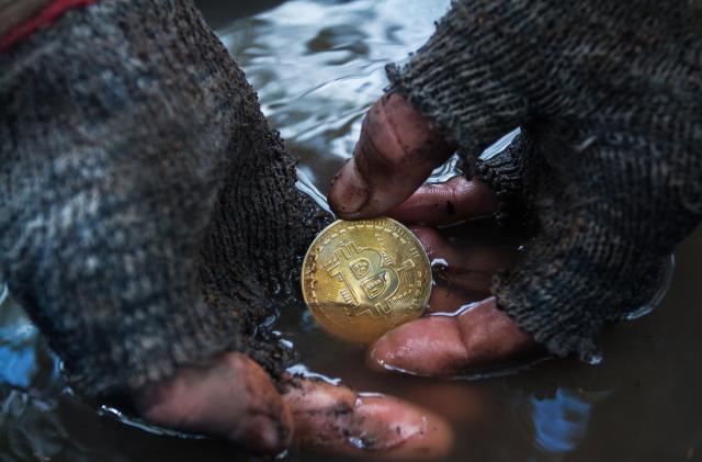 March 10, 2018 Thailand, Koh phangan: Dirty man's hands found in the ground a bitcoin coin. Photo was taken during the shooting of a short film on the topic of cryptocurrency Denis Kartavenko for his project on YouTube