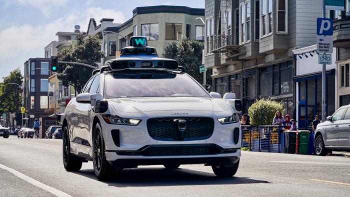 Waymo's autonomous vehicle driving on a street.                               