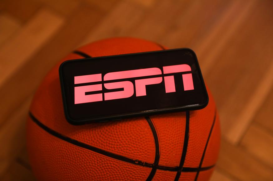 ESPN logo displayed on a phone screen and a basketball are seen in this illustration photo taken in Krakow, Poland on December 1, 2022. (Photo by Jakub Porzycki/NurPhoto via Getty Images)