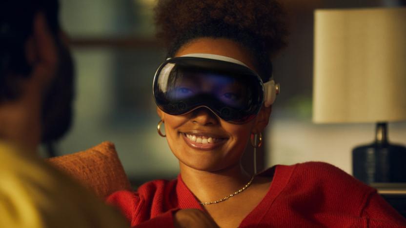 A person smiles while wearing the Apple Vision Pro headset.