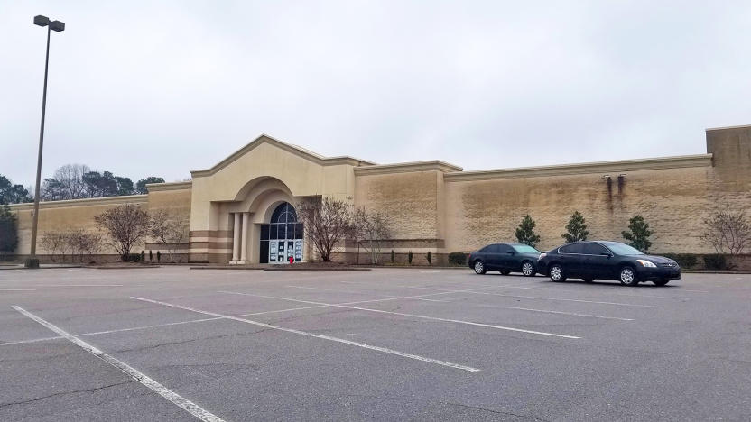 A mostly empty shopping mall parking lot and the building that will soon house Epic Games offices.