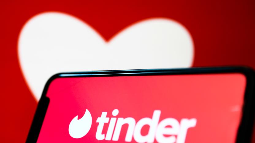 Tinder logo displayed on a phone screen and a heart shape displayed on a screen in the background are seen in this illustration photo taken in Krakow, Poland on February 13, 2022. (Photo by Jakub Porzycki/NurPhoto via Getty Images)