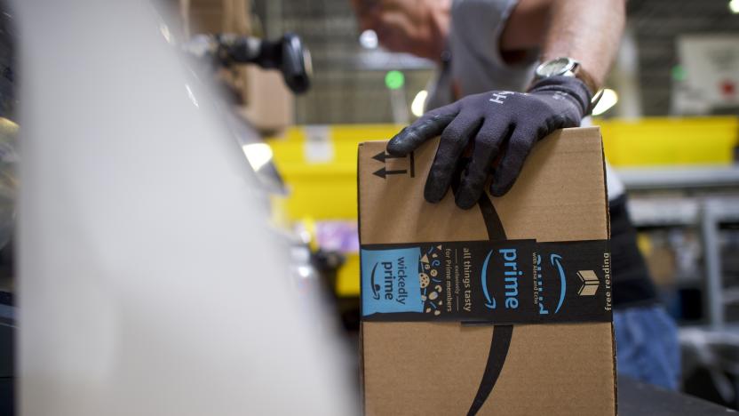 ROBBINSVILLE, NJ - AUGUST 1:  A worker boxes orders at the Amazon Fulfillment Center on August 1, 2017 in Robbinsville, New Jersey.  The more than 1 million square feet facility holds tens of millions of products, features more than 14 miles of conveyor belts, and employs more than 4,000 workers who pick, pack, and ship orders.  Tomorrow Amazon will host a jobs fair to hire 50,000 positions in their fulfillment centers nationwide.  (Photo by Mark Makela/Getty Images)