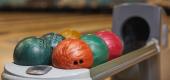 Bowling balls on a rack. (Getty Images)