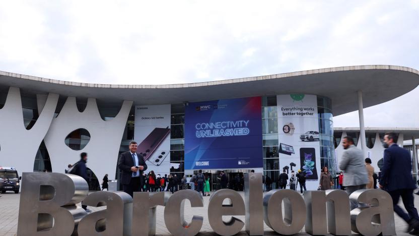 People walk past a "Barcelona" sign outside GSMA's 2022 Mobile World Congress (MWC) in Barcelona, Spain February 28, 2022. REUTERS/Nacho Doce