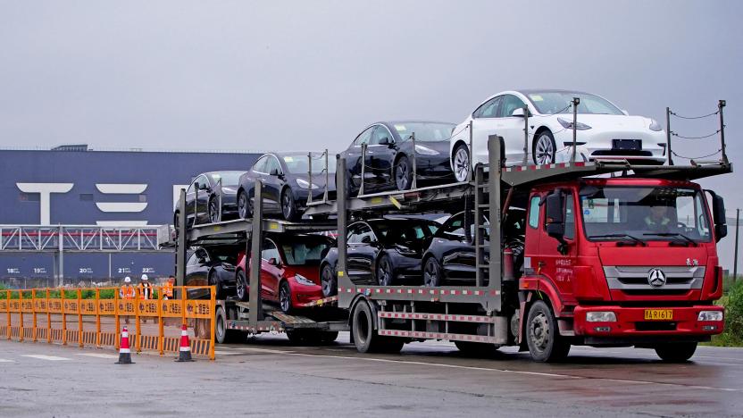 FILE PHOTO: A truck transports new Tesla cars at its factory in Shanghai.